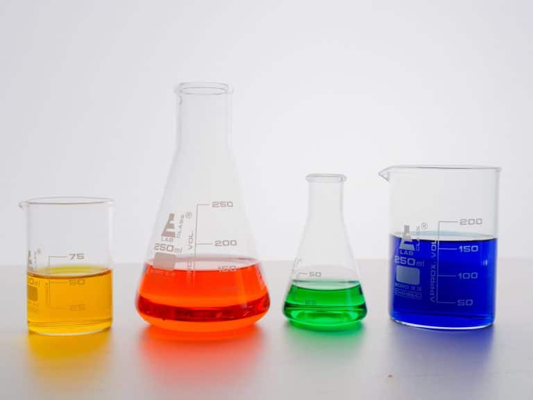 Colorful liquid chemicals in beakers.